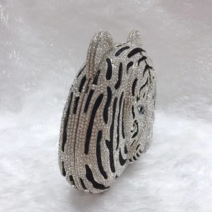 Side view of tiger head evening clutch bag featuring rhinestones and crystal stripes