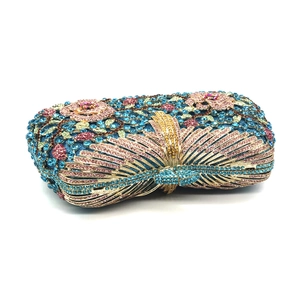 Macro detail of luxury crystal evening bag featuring floral patterns and rhinestones
