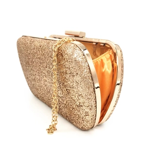 Detail view of gold glitter evening clutch bag with metal frame and chain strap