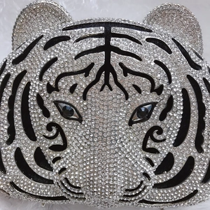 Close-up of sparkling crystal rhinestones and black stripe details on tiger evening bag