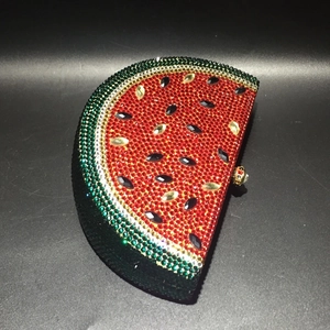 Detailed view of the watermelon crystal clutch featuring red and green rhinestones and metal clasp