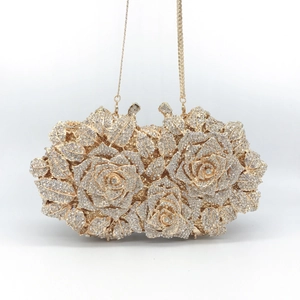 Elegant gold hollow rose clutch bag with sparkling white crystals and fine metal chain