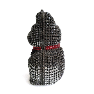 Macro shot of luxury lucky cat evening bag with sparkling black and white crystals
