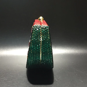 Side view of crystal watermelon clutch bag showing structured wedge shape and luxury rhinestones