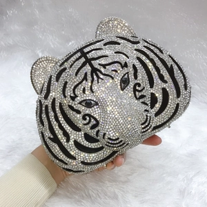 Detailed close-up of tiger head evening clutch with sparkling rhinestones and black stripes