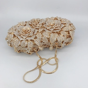 Detailed view of luxury gold rose-shaped evening clutch with sparkling rhinestone finish
