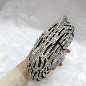 Macro shot of tiger head clutch featuring sparkling rhinestones and crystal animal patterns