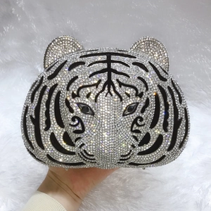 Detailed close-up of tiger head evening clutch bag with sparkling crystals and black gemstones