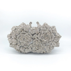 Macro shot of silver hollow rose clutch bag with sparkling inlaid rhinestones