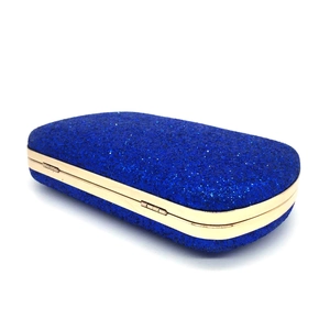 Detail of navy blue sequin evening clutch with gold metal frame and side hinges
