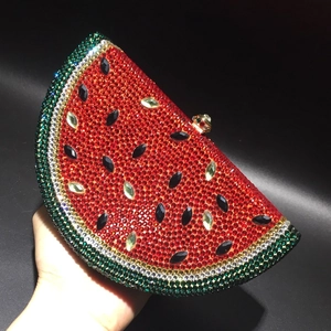 Macro detail of watermelon-shaped evening bag featuring red and green rhinestones