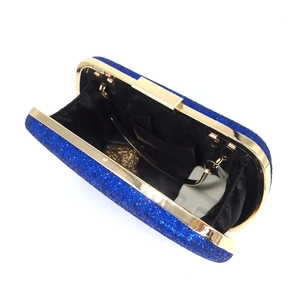 Detail of royal blue sequined clutch with gold metal frame and interior pocket