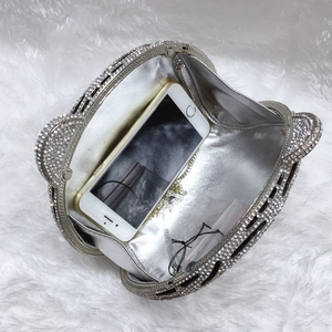 Detailed interior of tiger head clutch showing silver lining and space for a smartphone