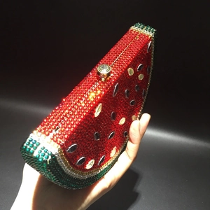 Detailed close-up of watermelon-shaped clutch with sparkling hand-set rhinestones
