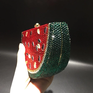 Detailed close-up of watermelon slice evening clutch with sparkling red and green crystals