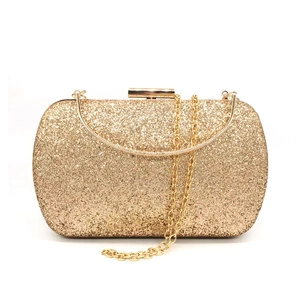 Detail of gold sequin evening clutch with metallic buckle and detachable chain straps