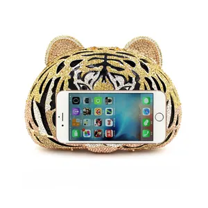 Tiger head evening clutch showing interior capacity to fit a smartphone easily