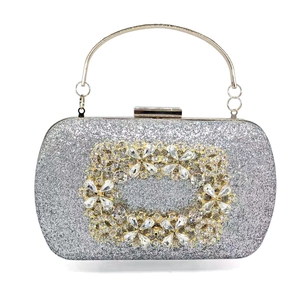 Silver glitter evening clutch with crystal floral buckle and gold metal handle
