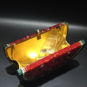Macro shot of watermelon evening clutch with crystal rhinestones and gold metal lining