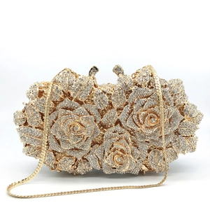 Detailed macro view of the intricate hollow rose pattern and sparkling crystal rhinestones