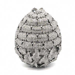 Luxurious egg-shaped silver crystal evening clutch bag with leaf-engraved metal top closure