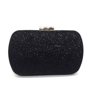 Close-up of black sequin evening clutch bag with elegant golden rectangular metal clasp