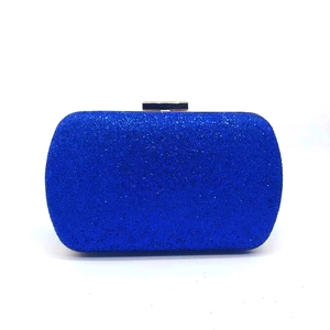 Close-up of royal blue sequined evening bag with golden clasp and glitter texture