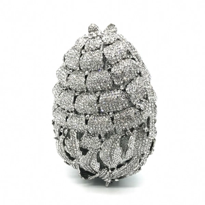 Close-up of pinecone shaped silver evening bag with sparkling inlaid crystals