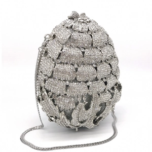 Macro view of pineapple pattern diamond evening clutch with silver hollow metal and crystals