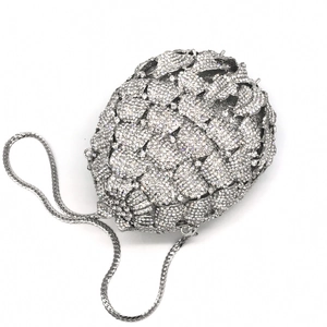 Close-up of silver pineapple pattern evening clutch with sparkling rhinestones and chain