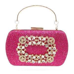 Hot pink sequin clutch bag detail with floral crystal buckle and golden metal handle