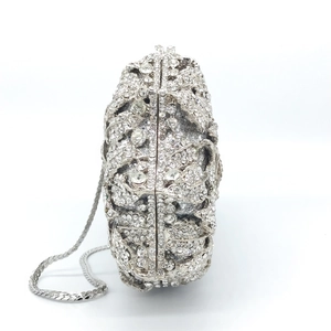 Detailed side view of the silver hollow rose evening clutch with sparkling crystals