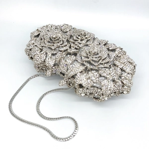 Close-up of sparkling silver rose evening bag with luxury rhinestone crystal petals