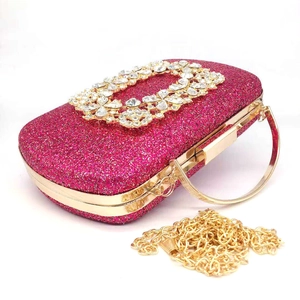 Macro view of sparkly rose red sequin evening clutch bag with square crystal buckle