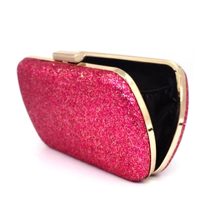 Detail of rose red sequin evening clutch with golden metal frame and rectangular buckle