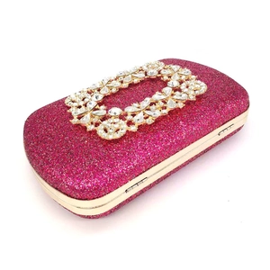 Macro shot of fuchsia glitter surface and sparkling rectangular crystal buckle detail