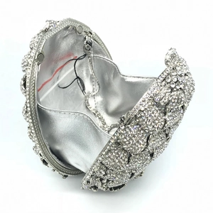 Detail of silver evening clutch interior with sparkling crystals and metal chain strap