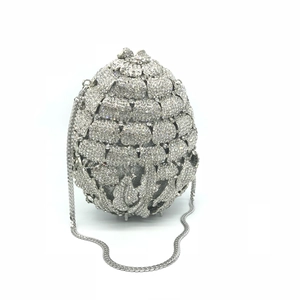 Detail shot of shimmering silver crystal pineapple pattern on a metallic clutch bag