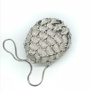 Macro shot of silver pineapple-patterned clutch with sparkling crystals and chain