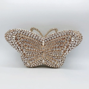 Close-up of golden butterfly evening clutch featuring intricate crystal studding detail