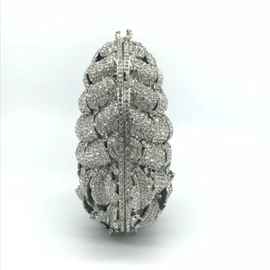 Detailed view of silver pineapple pattern evening clutch bag with sparkling rhinestones