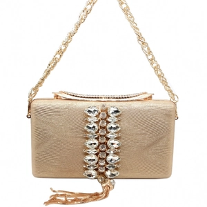 Detailed view of the gold evening bag with sparkling rhinestones and metallic tassels