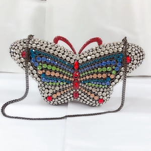 Close-up of butterfly evening clutch with multi-colored crystals and metal chain