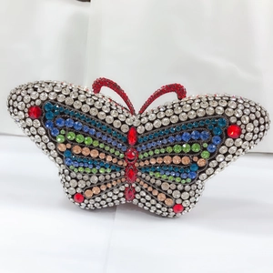 Macro shot of colorful rhinestone butterfly clutch with intricate crystal wing patterns