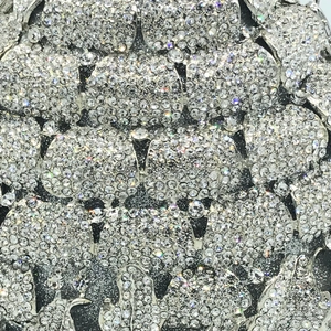 Macro detail of sparkling pineapple crystal pattern on the hollow metal evening bag