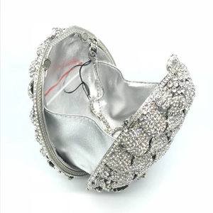 Macro detail of silver diamond evening clutch with metal chain and rhinestone texture