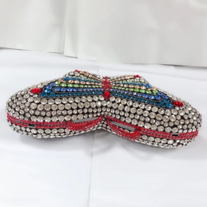 Macro shot of silver crystal butterfly clutch bag with colorful rhinestones on metal frame
