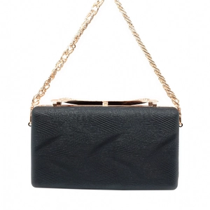Detail view of black evening clutch with wavy texture and elegant gold metal frame chain