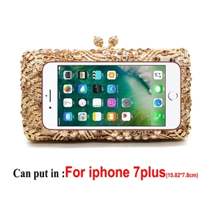 Detailed size reference of a gold floral rhinestone evening clutch next to an iPhone