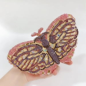 Detailed close-up of pink butterfly evening clutch featuring luxury rhinestones and gold frame